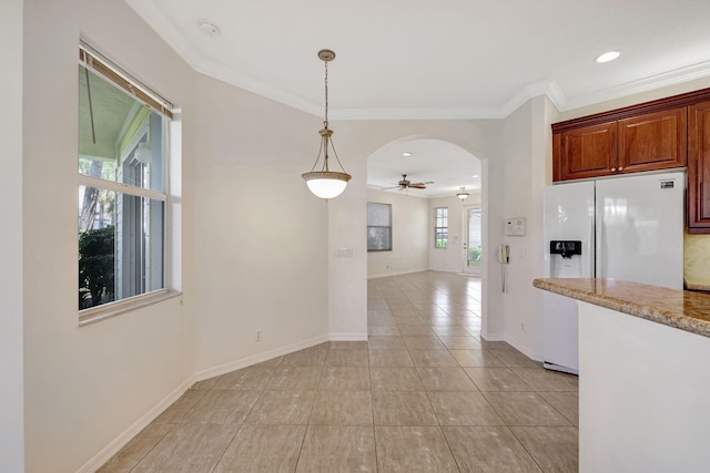 kitchen featuring ceiling fan, light tile floors, hanging light fixtures, crown molding, and white refrigerator with ice dispenser