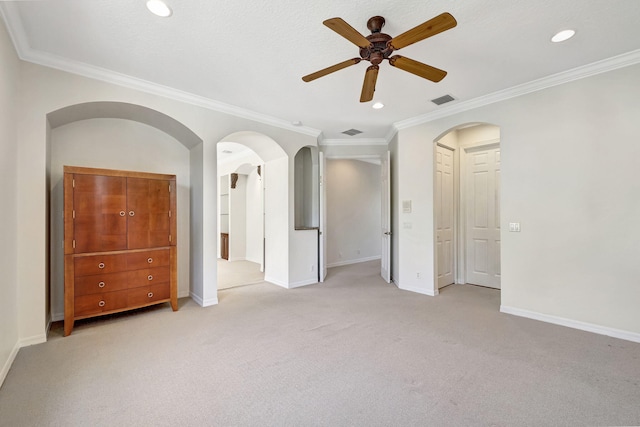 unfurnished bedroom featuring ornamental molding, carpet flooring, and ceiling fan