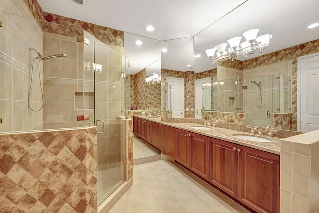 bathroom featuring walk in shower, tile floors, a textured ceiling, and double sink vanity