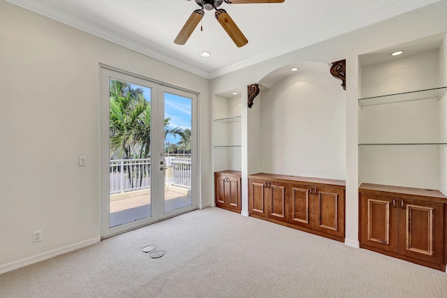 empty room featuring light carpet, french doors, and a wealth of natural light