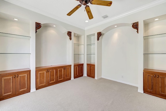 spare room featuring ornamental molding, light carpet, and ceiling fan