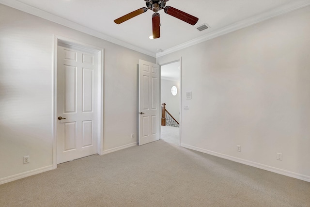 unfurnished bedroom with ornamental molding, ceiling fan, and carpet flooring