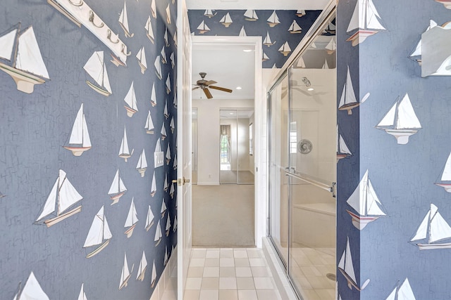 bathroom with tile flooring, ceiling fan, and a shower with shower door