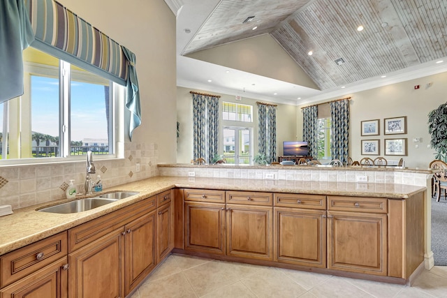 kitchen featuring a healthy amount of sunlight, sink, and light tile floors