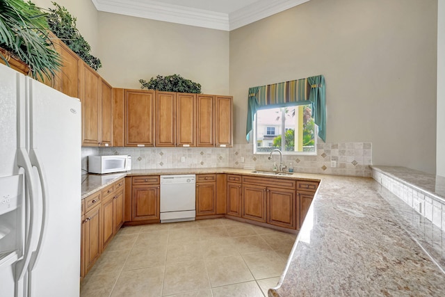 kitchen with sink, white appliances, tasteful backsplash, light tile flooring, and a high ceiling