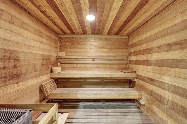 view of sauna with wooden ceiling, hardwood / wood-style floors, and wooden walls