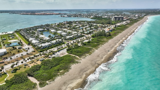 drone / aerial view featuring a water view and a view of the beach