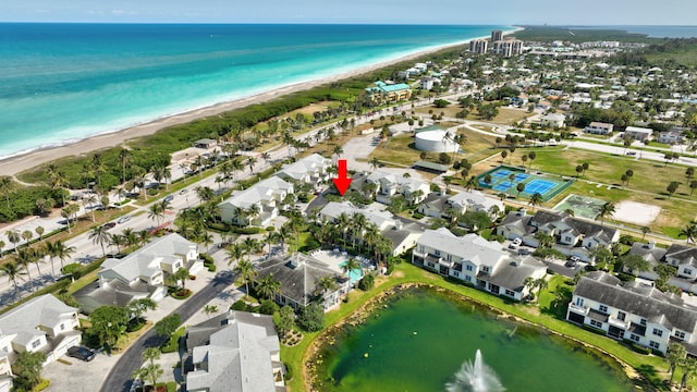 birds eye view of property featuring a beach view and a water view