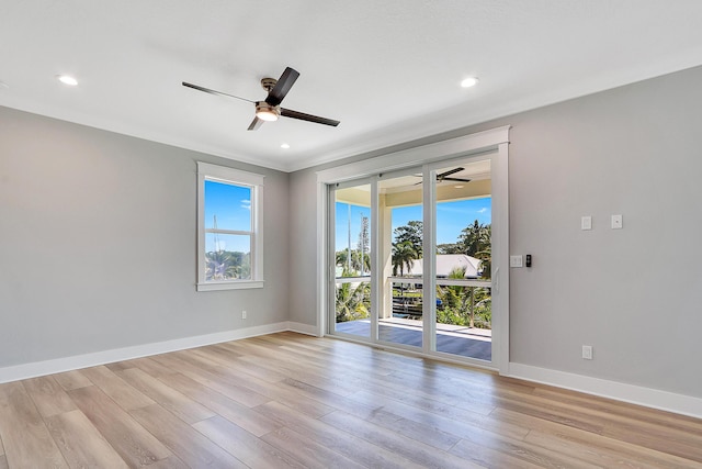 unfurnished room featuring light hardwood / wood-style floors, ceiling fan, and crown molding