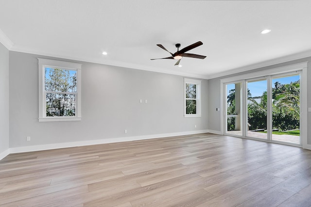 empty room with ceiling fan, light hardwood / wood-style floors, and ornamental molding