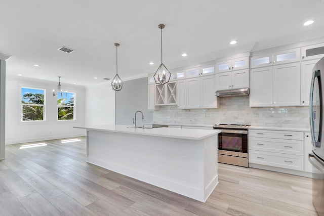 kitchen with stainless steel range, sink, decorative light fixtures, a center island with sink, and white cabinets