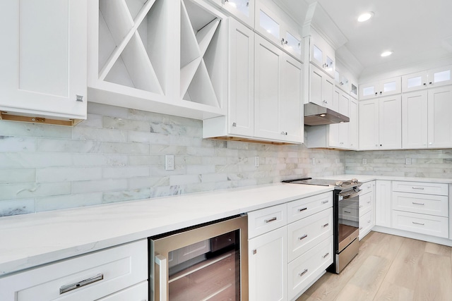 kitchen with white cabinetry, wine cooler, stainless steel electric stove, and light hardwood / wood-style floors