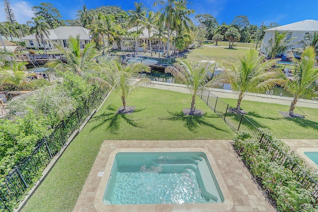 view of pool featuring a lawn