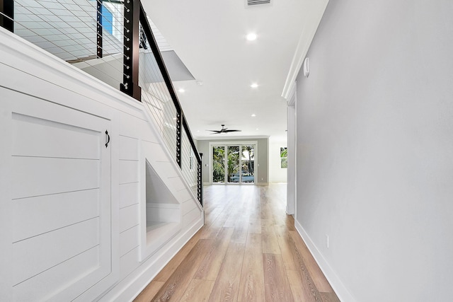 hallway with light hardwood / wood-style floors