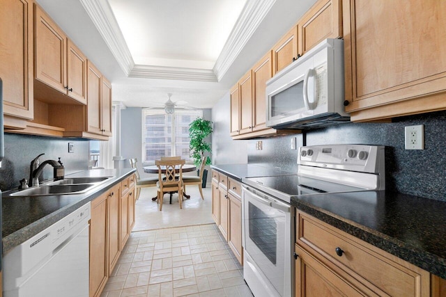 kitchen with ceiling fan, a raised ceiling, sink, crown molding, and white appliances