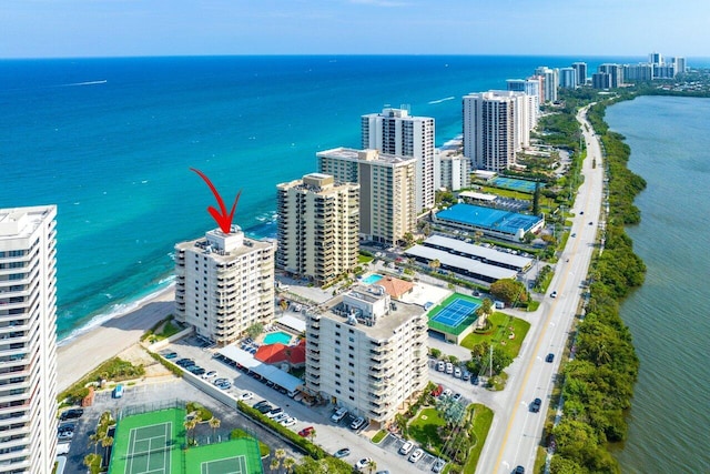 drone / aerial view with a water view and a beach view