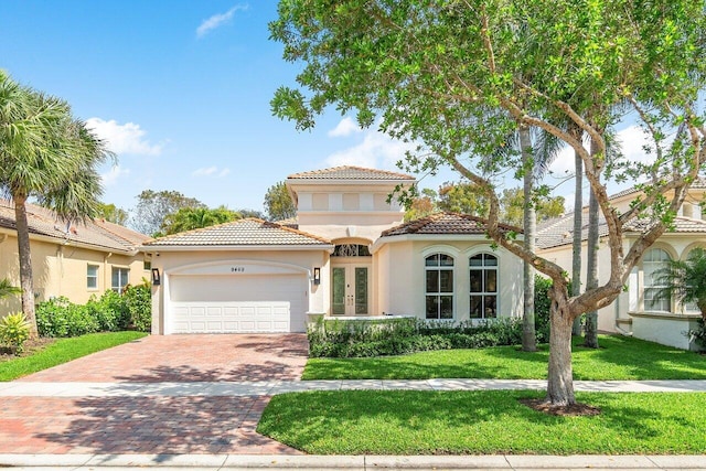 mediterranean / spanish home featuring french doors, a front lawn, and a garage