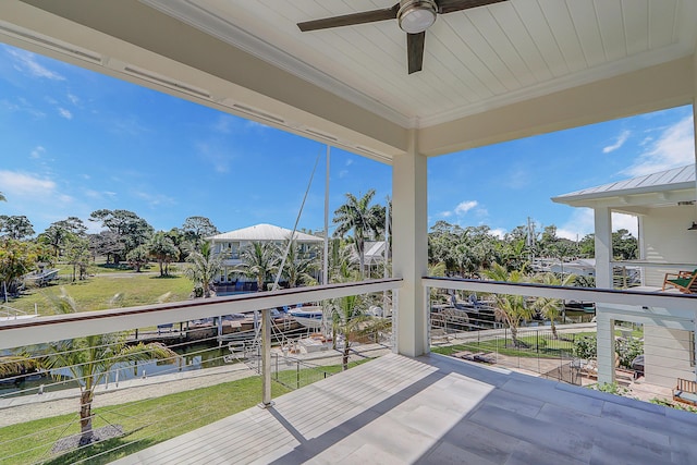 wooden terrace featuring ceiling fan and a water view