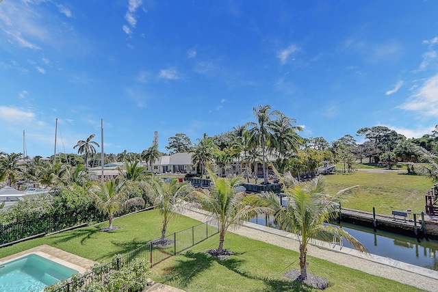 view of home's community with a lawn and a water view