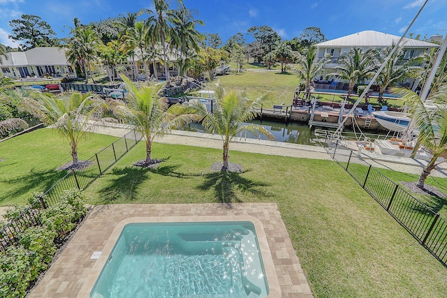 view of pool with a lawn, a water view, and a patio