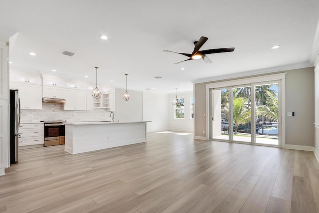 unfurnished living room featuring light wood-type flooring, ceiling fan, ornamental molding, and sink