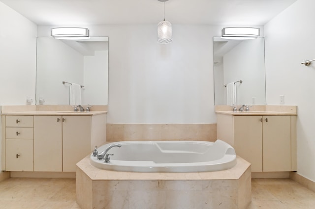 bathroom with tile floors, a relaxing tiled bath, and vanity