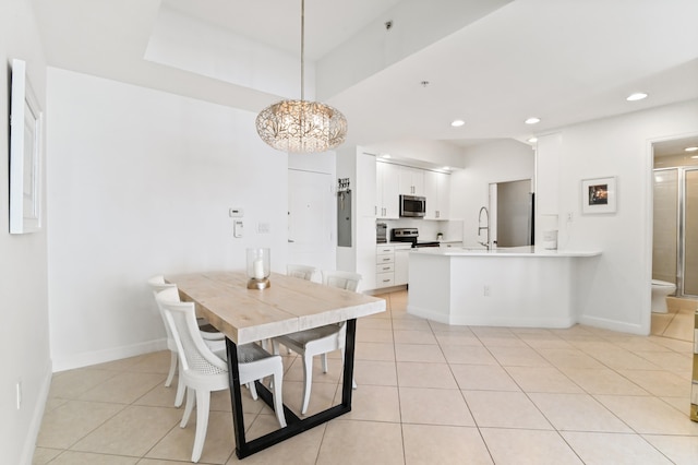 tiled dining area with a notable chandelier and sink