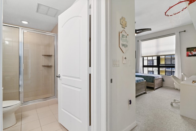 bathroom with tile flooring, an enclosed shower, ceiling fan, and toilet