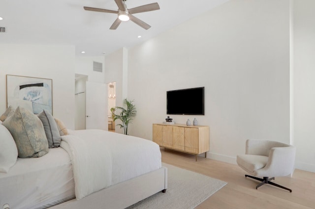 bedroom featuring light hardwood / wood-style flooring, high vaulted ceiling, and ceiling fan