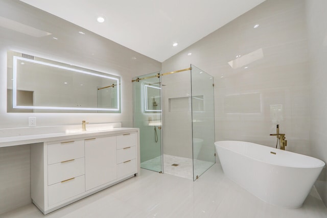 bathroom with tile flooring, vanity, tile walls, and plus walk in shower