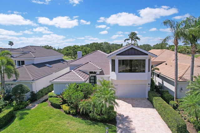 view of front facade with a garage and a front lawn