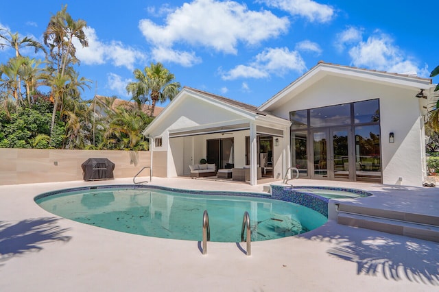 view of pool featuring a patio area, ceiling fan, and an in ground hot tub