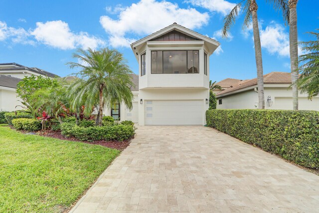 view of front of house featuring a garage and a front yard