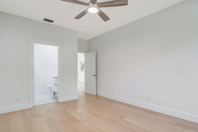 unfurnished bedroom with connected bathroom, ceiling fan, and light wood-type flooring