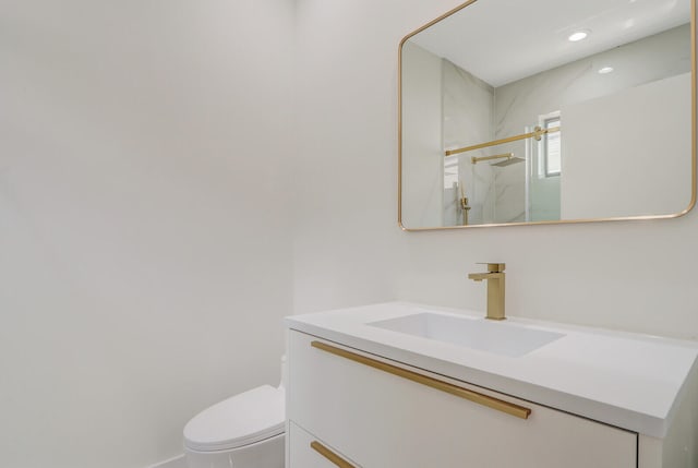 bathroom with large vanity and toilet