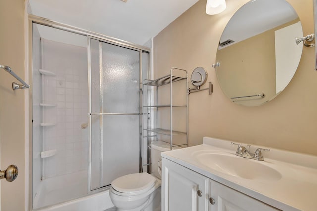 bathroom featuring vanity, toilet, and walk in shower