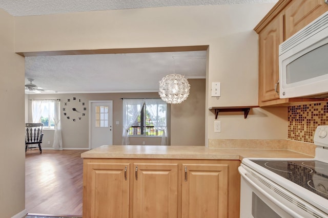 kitchen with white appliances, kitchen peninsula, decorative backsplash, light brown cabinetry, and wood-type flooring