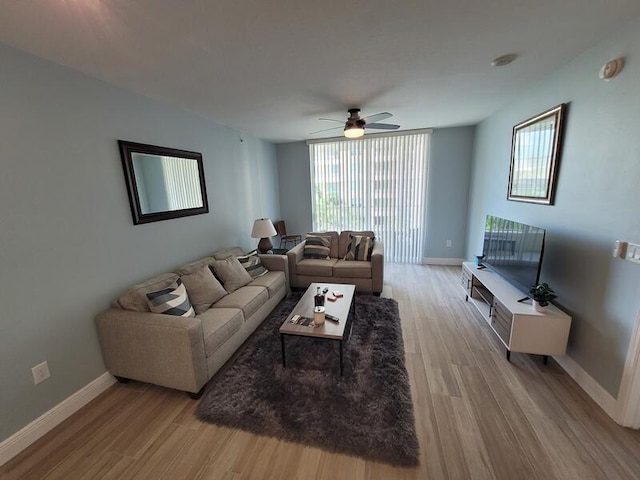 living room with ceiling fan and light wood-type flooring