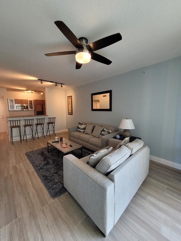 living room with light hardwood / wood-style flooring and ceiling fan