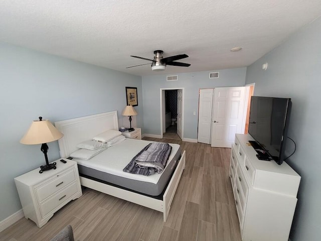 bedroom with light hardwood / wood-style floors and ceiling fan