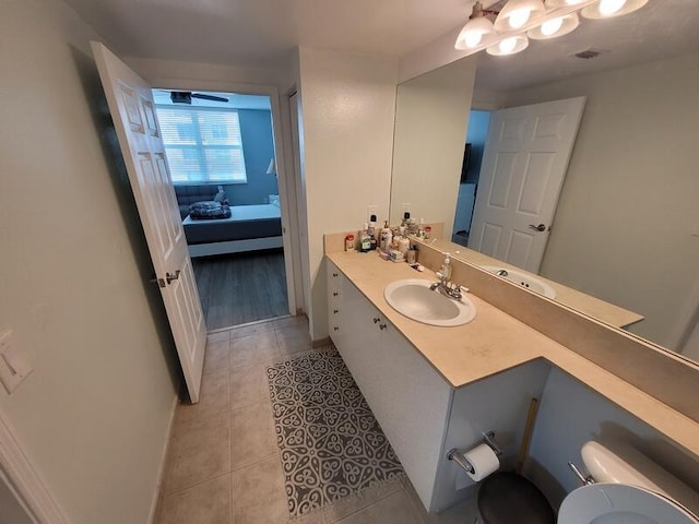 bathroom featuring toilet, vanity, ceiling fan, and hardwood / wood-style flooring