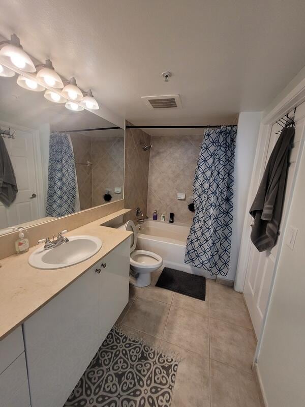 full bathroom featuring tile floors, toilet, shower / bathtub combination with curtain, and vanity