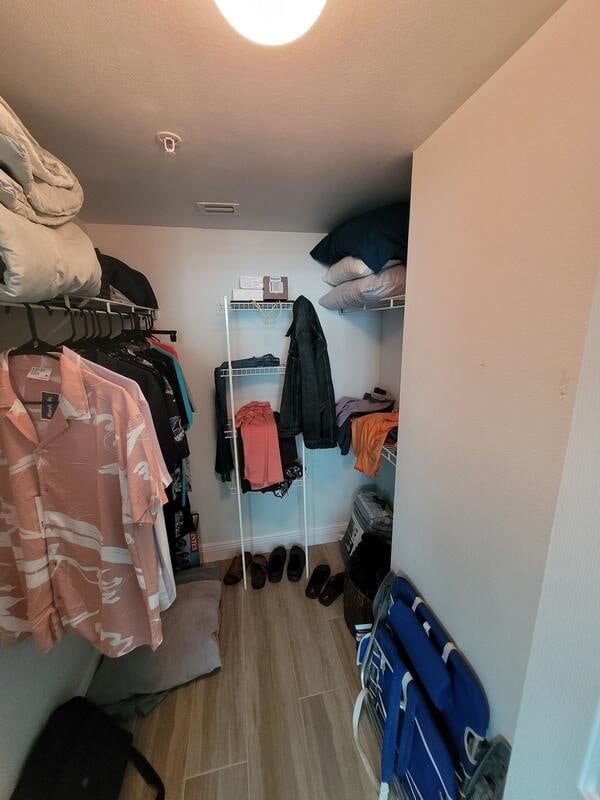 walk in closet with light wood-type flooring