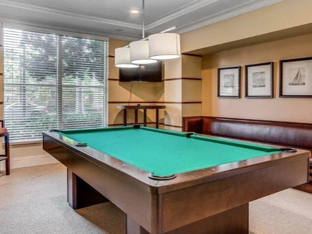 rec room with light colored carpet, ornamental molding, and pool table