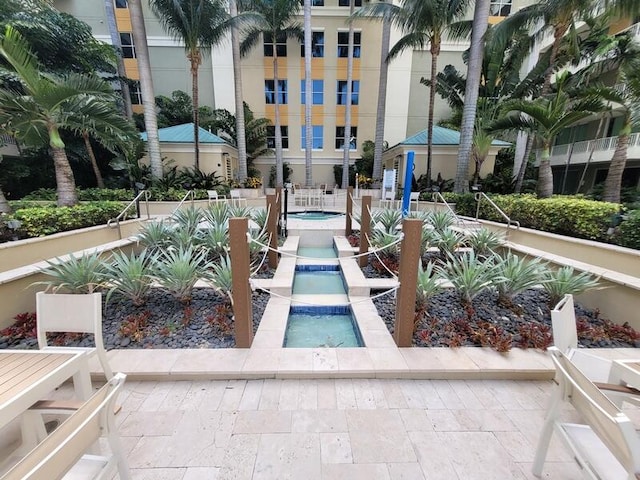 view of home's community with a pool and a patio area