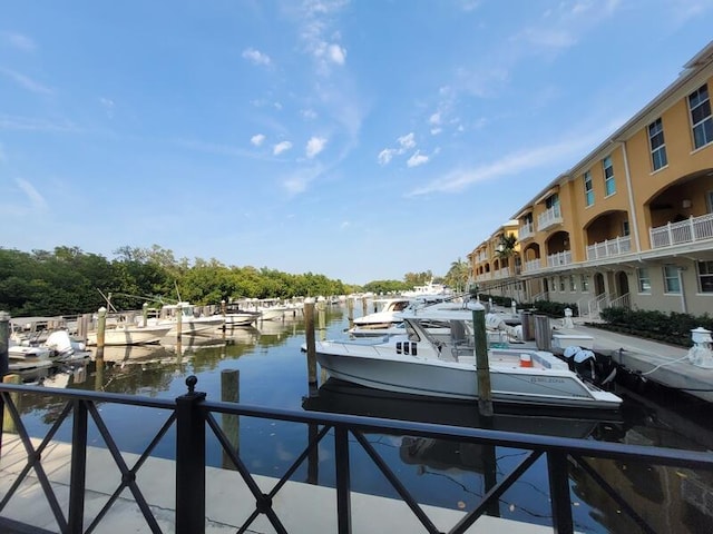 dock area featuring a water view and a balcony