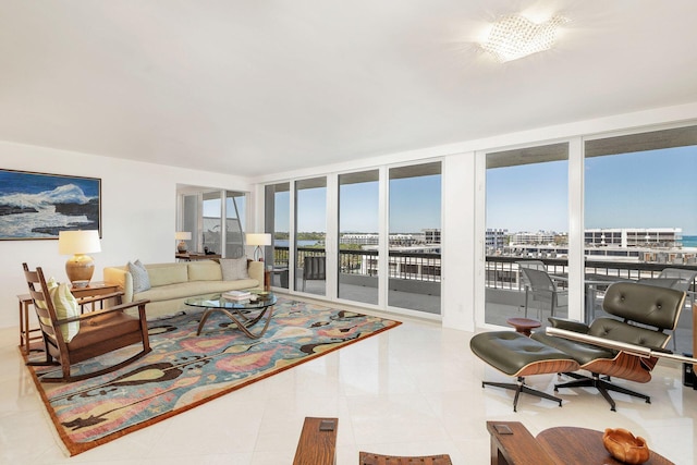 tiled living room with floor to ceiling windows and a chandelier