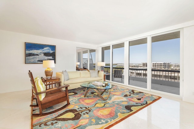 tiled living room featuring floor to ceiling windows