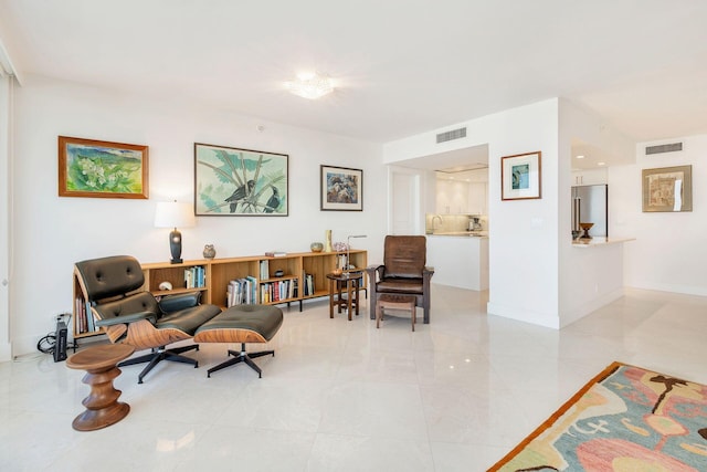 sitting room featuring light tile floors