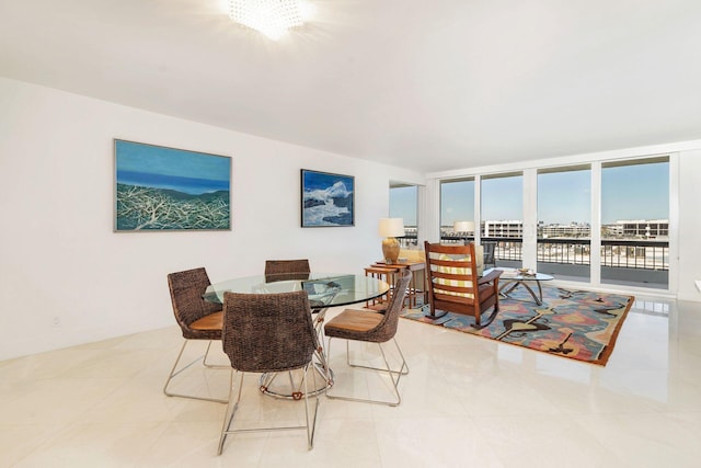 dining space with a chandelier, light tile floors, and expansive windows